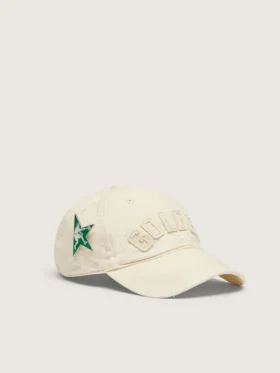 Cream baseball cap with tone-on-tone “Golden” patch and green star pin