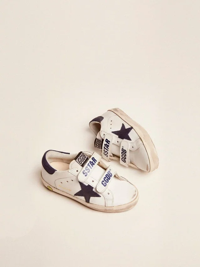 Old School Junior in white leather with blue suede star and heel tab
