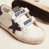 Old School Junior in white leather with blue suede star and heel tab