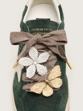 Skins “Sparkling” brown, black and silver herringbone laces with two appliqué charms
